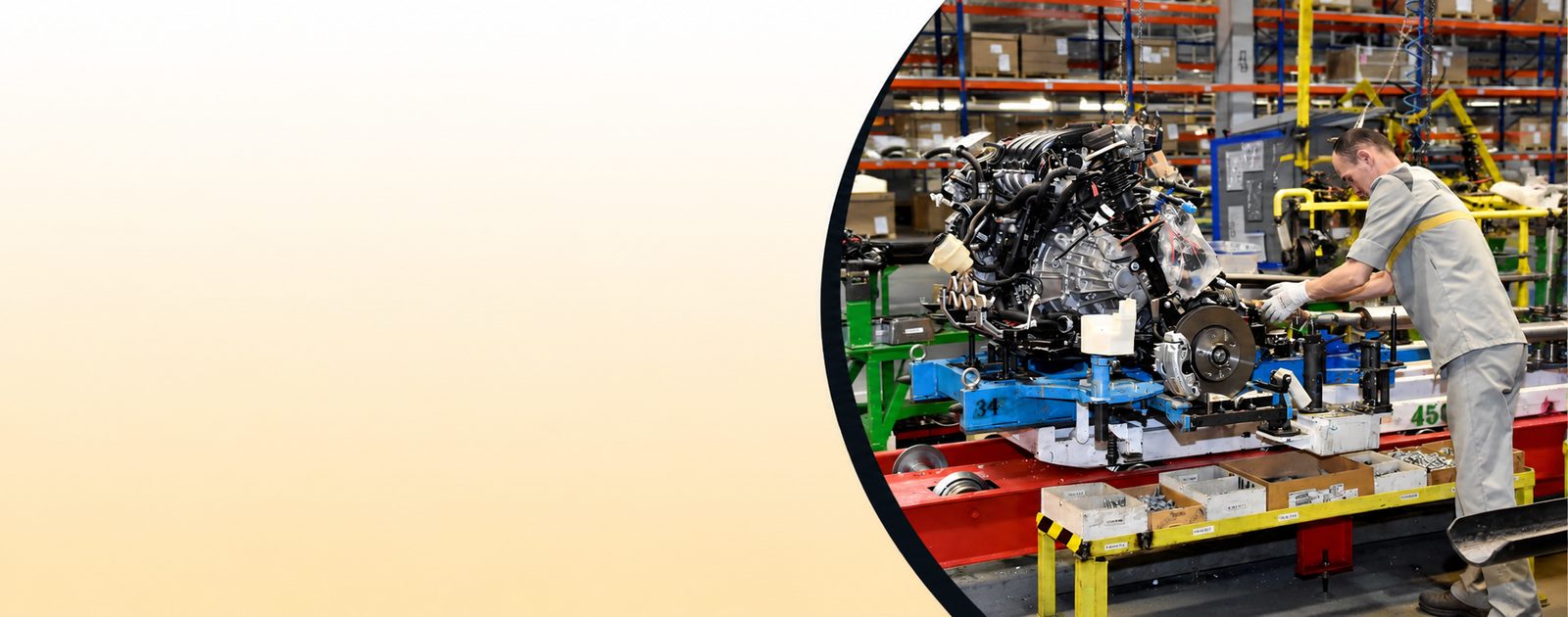 Worker assembling an engine on a production line