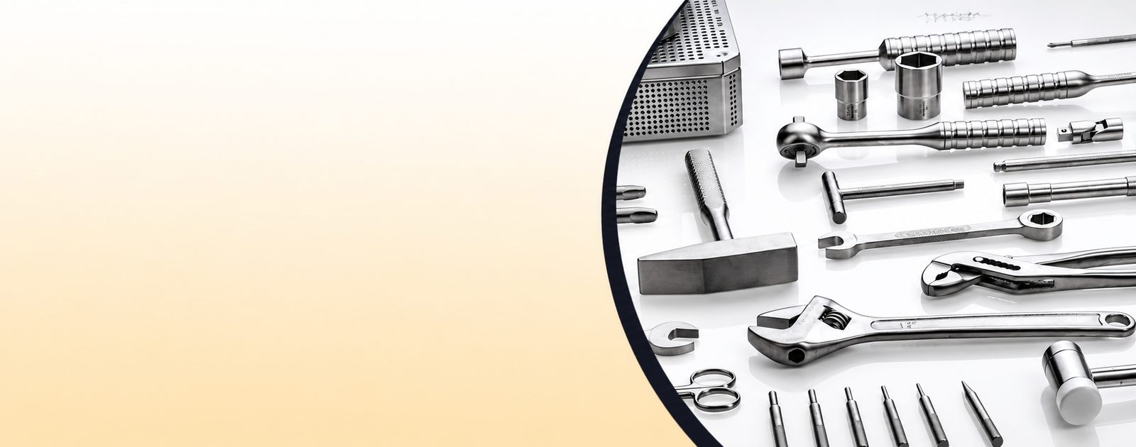Stainless steel hand tools laid out on a white surface
